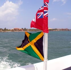 Cayman Islands and Jamaican flags displayed on the Ray Ex... by Andrew Kubica 